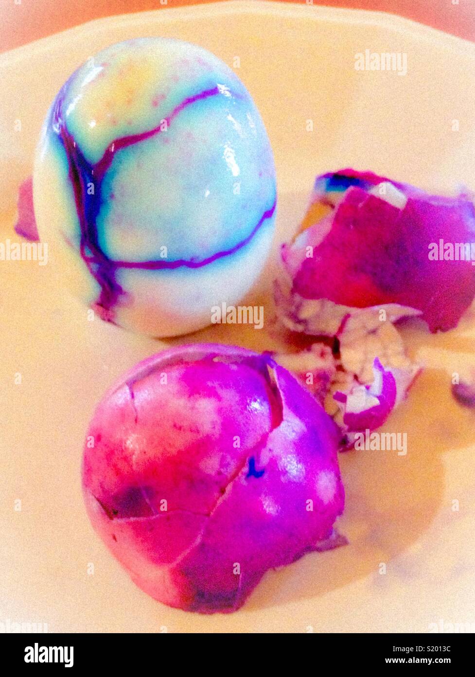 Vividly colored Easter egg, cracked in boil bath - Smartphone Captured Stock Image