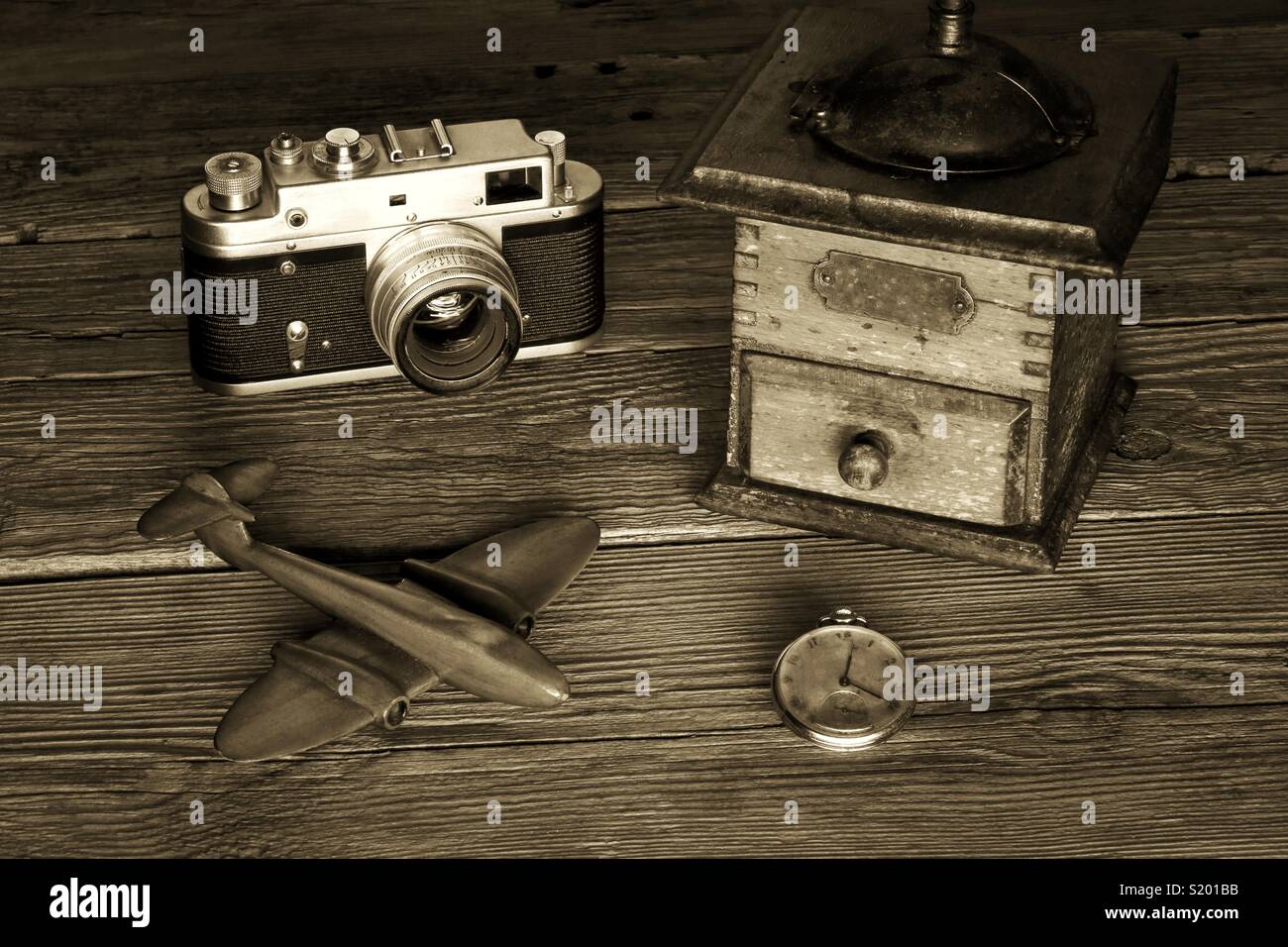 Vintage romantic mood - camera coffee grinder toy plane and a watch Stock Photo