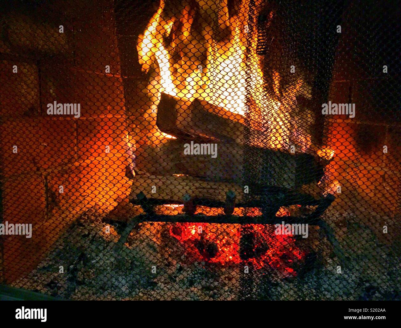 Fireplace burning brightly in luxury new England residence, USA - Smartphone Captured Stock Image