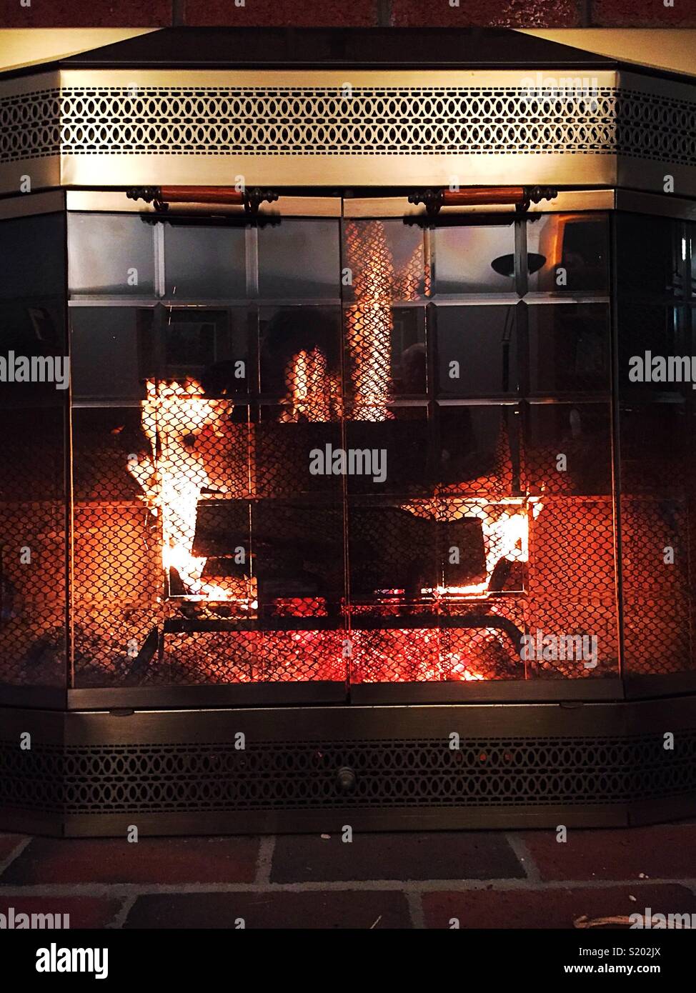 Fireplace Burning brightly in luxury new England residence, USA - Smartphone Captured Stock Image