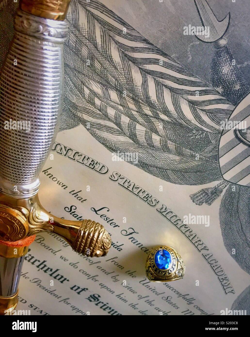 Cadet saber and graduate ring on United States military academy diploma