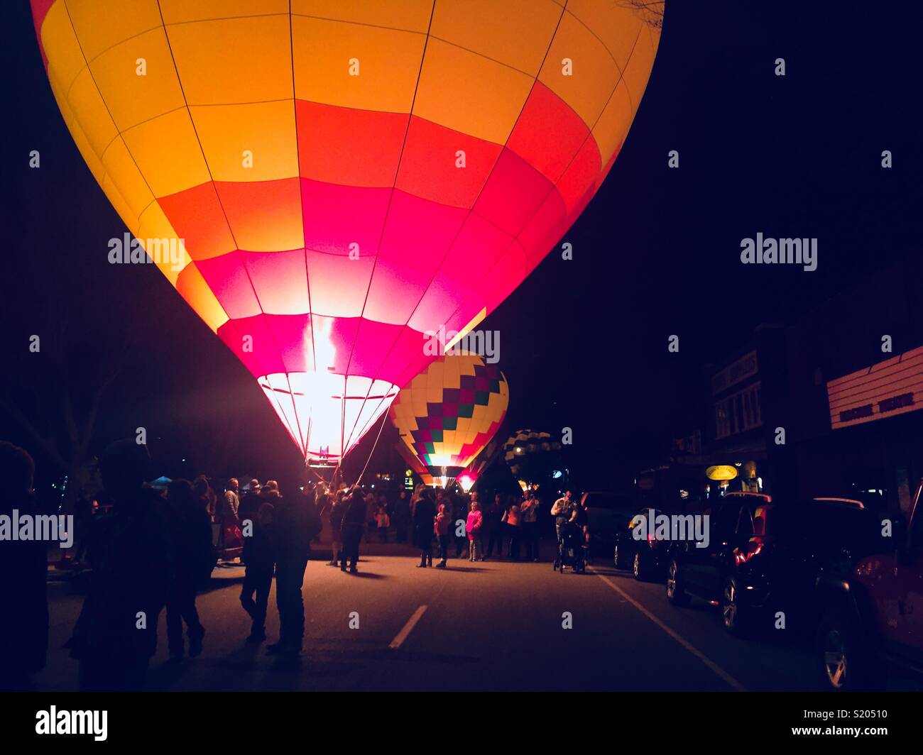 Two hot air balloons glowing at the Balloons and Tunes Festival, March, 2018 in Kanab, Utah. Stock Photo