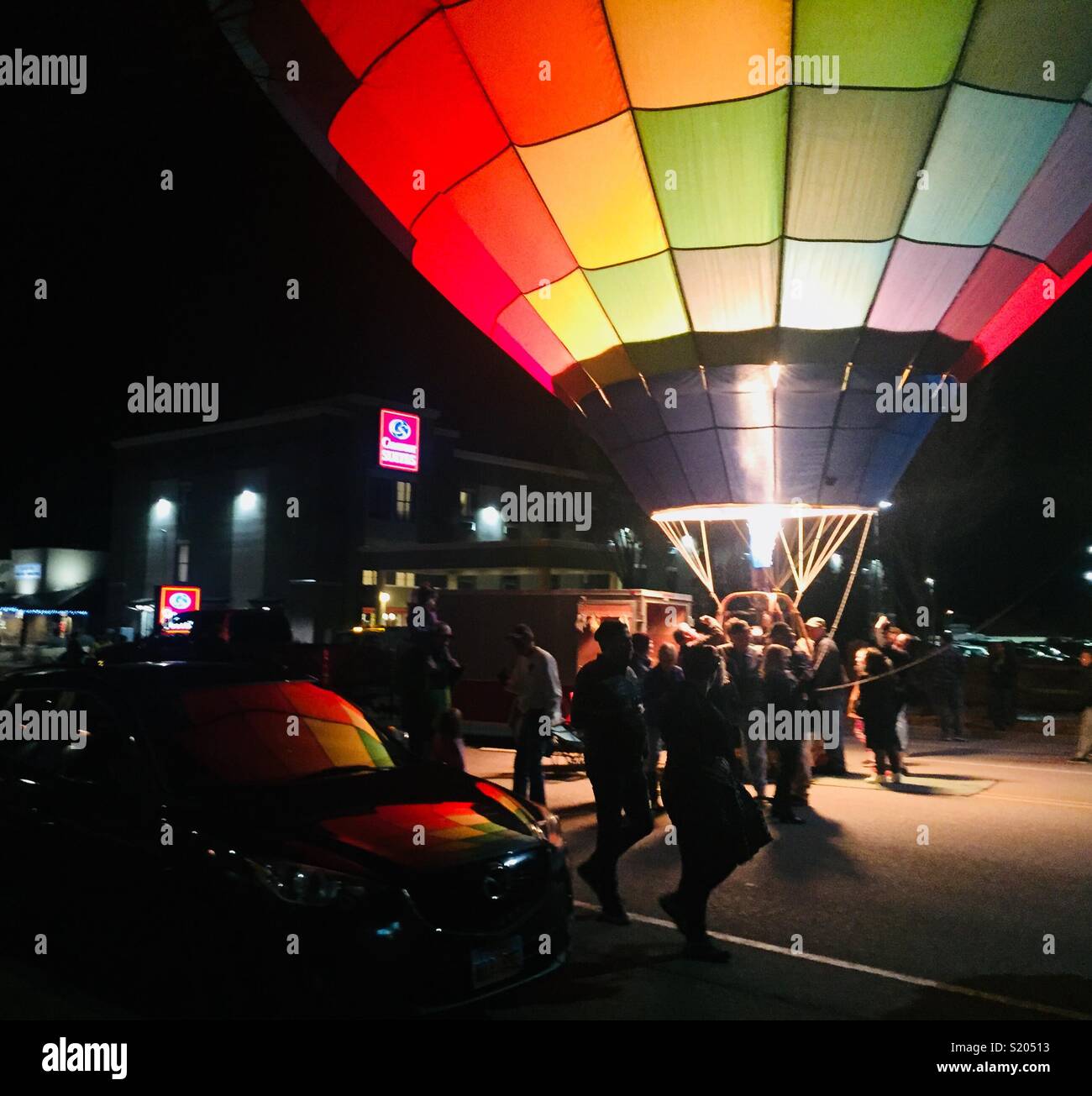 A crowd gathers around a glowing balloon at the balloons and tunes festival in Kanab, Utah in March, 2018. Stock Photo
