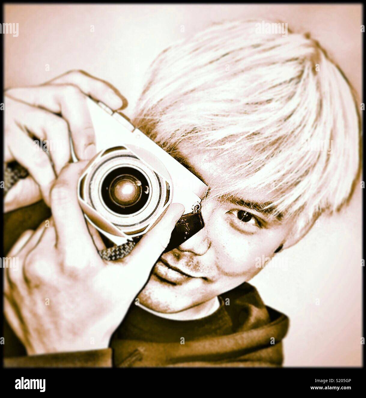 Young Oriental man holding a camera. - Smartphone Captured Stock Image