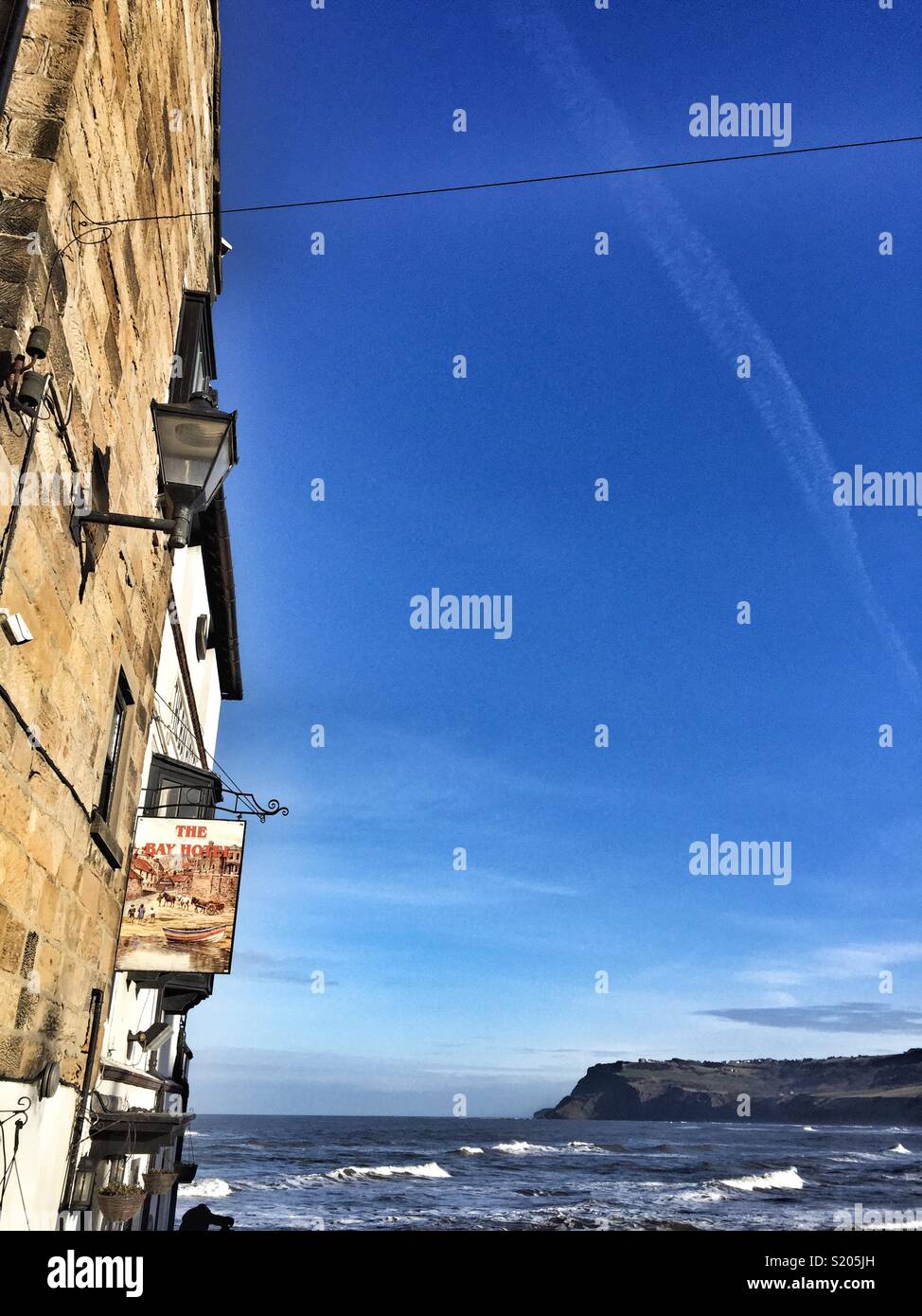 The Bay Hotel Pub on the coast of North Yorkshire in Robin Hood’s Bay, UK, east coast - Smartphone Captured Stock Image