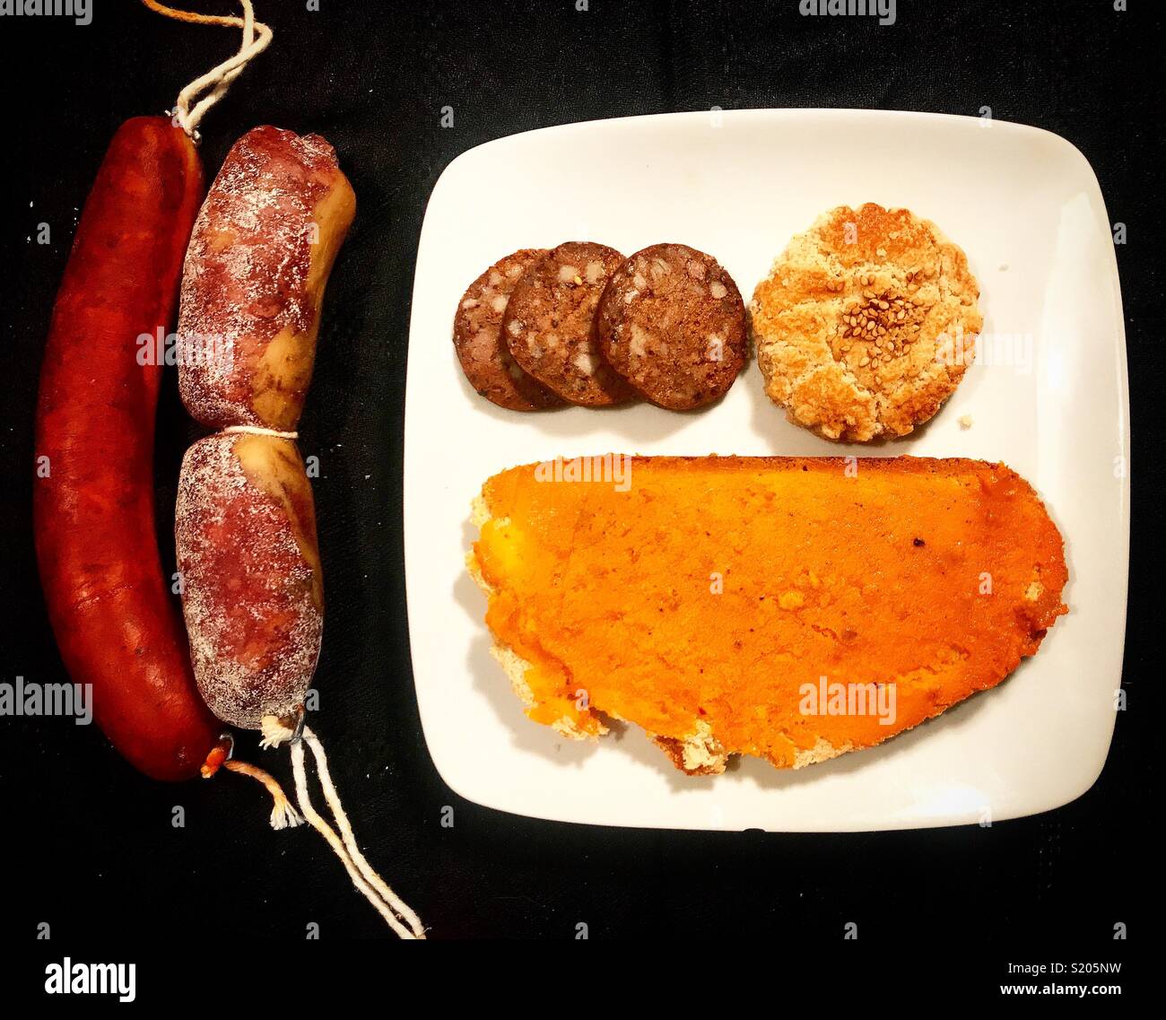 Sausage, salamy, blood sausage and bread with lard from Iberian pigs and a cookie in Carniceria