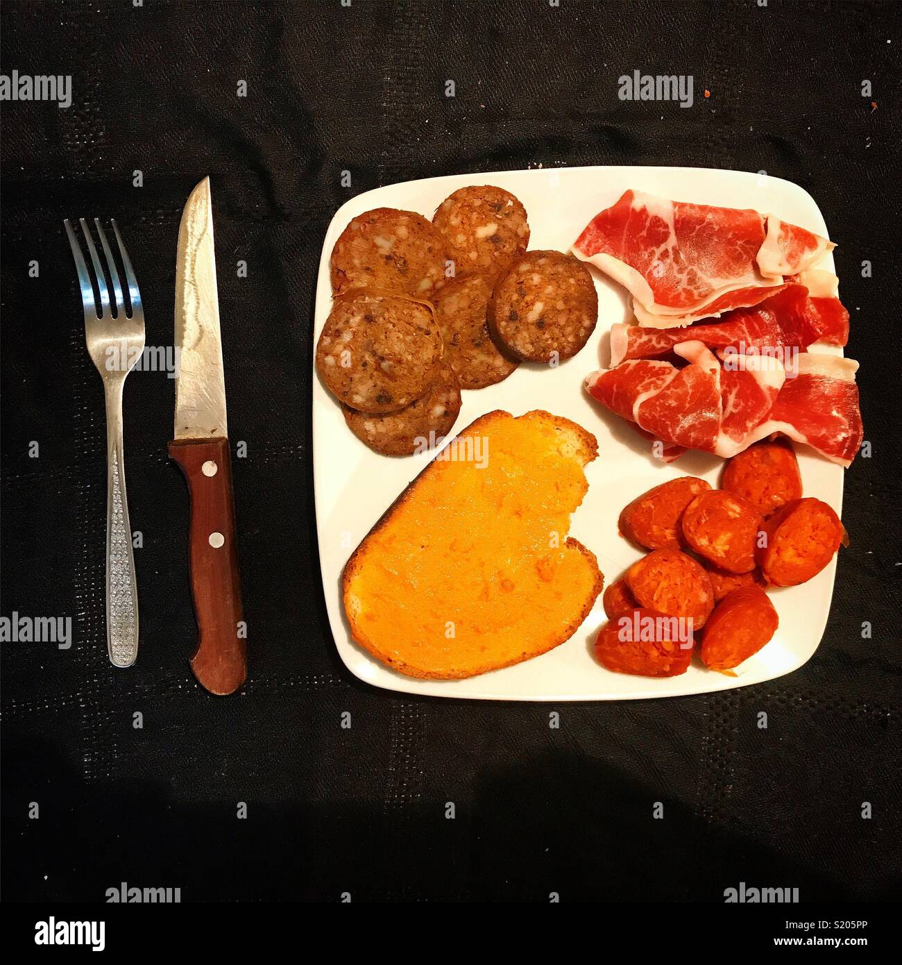 Blood sausage, cured ham, sausage y toasted bread with lard in Carniceria Ana, Prado del Rey