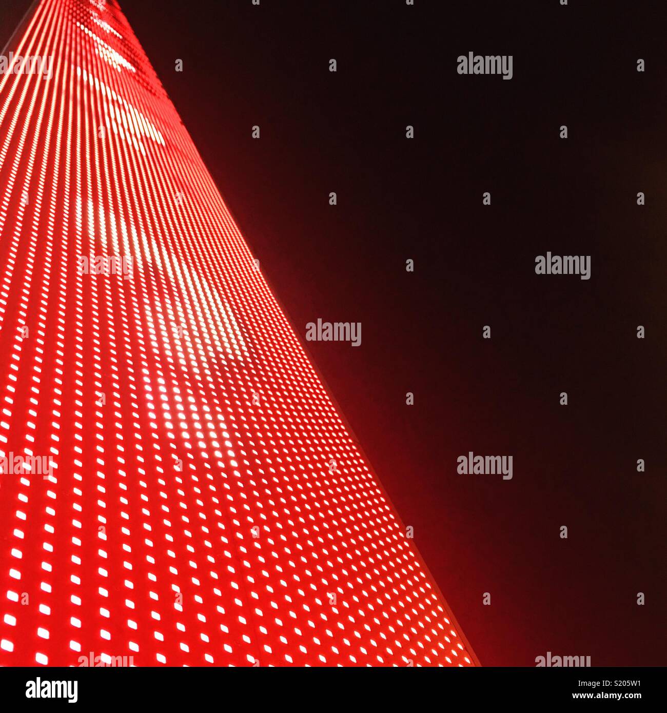 Red neon lights with question marks rising. - Smartphone Captured Stock Image