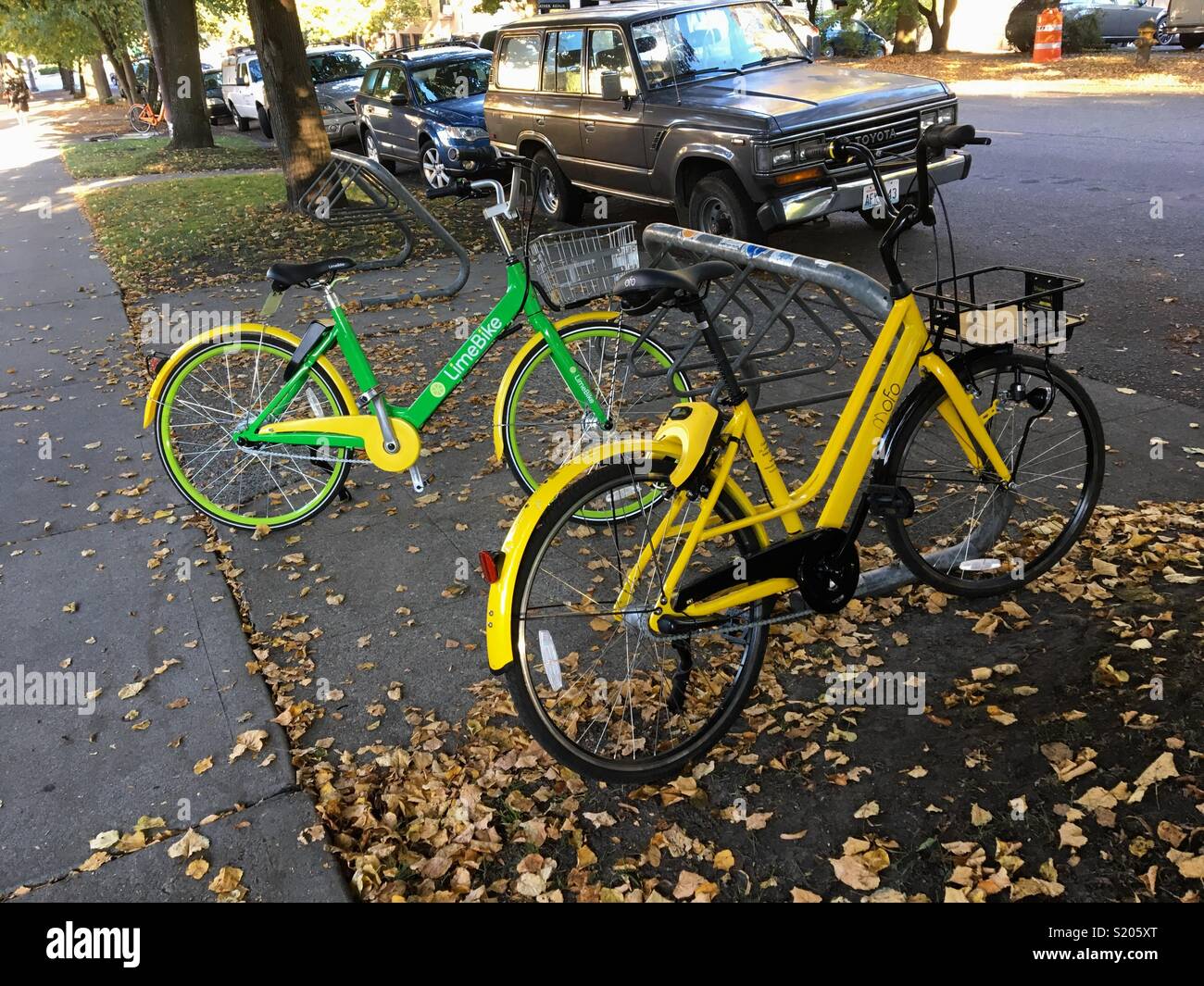 Two bicycles from two different bikesharing companies on a
