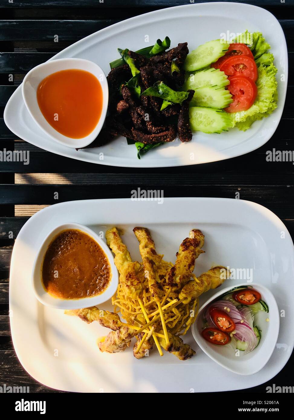 Thailand appetizers chicken satay and fried beef with chili sauce