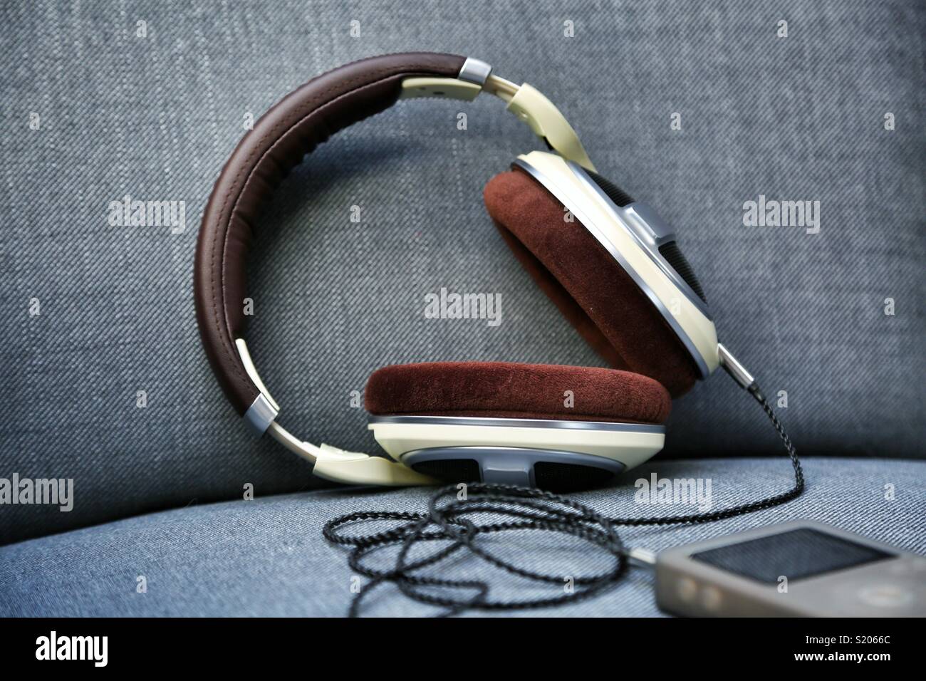 Earphones with mp3 player against grey fabric background Stock Photo Alamy