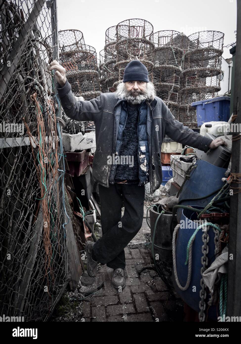 A trawlerman seen with his fish traps at the Camber Docks in Old Portsmouth, Hampshire Stock Photo