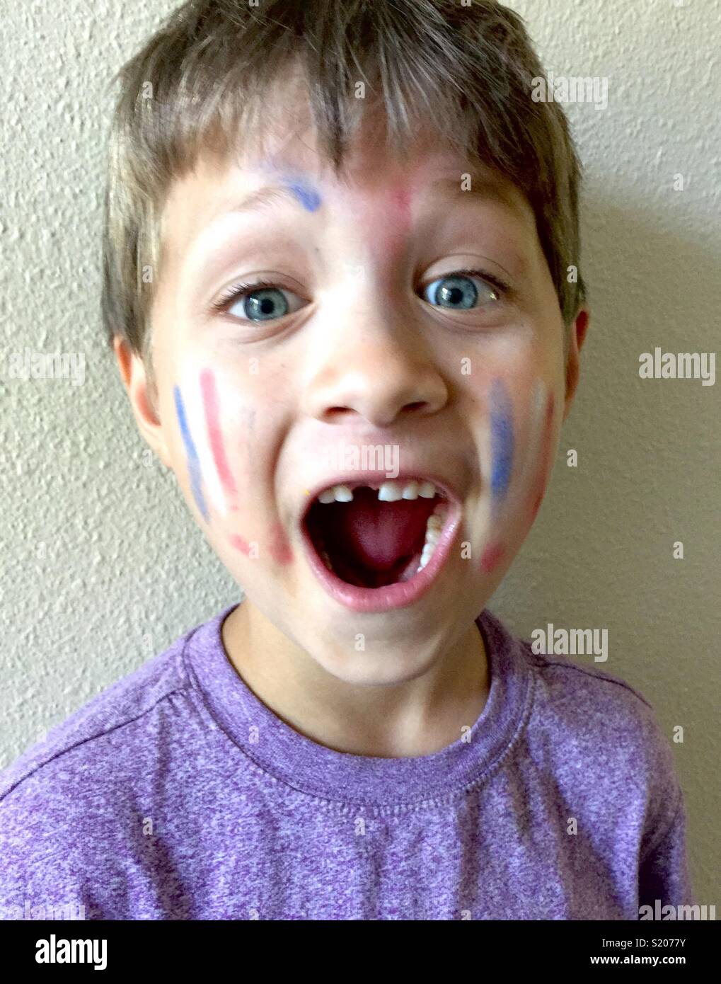 Boy with mouth open with marker on his face Stock Photo