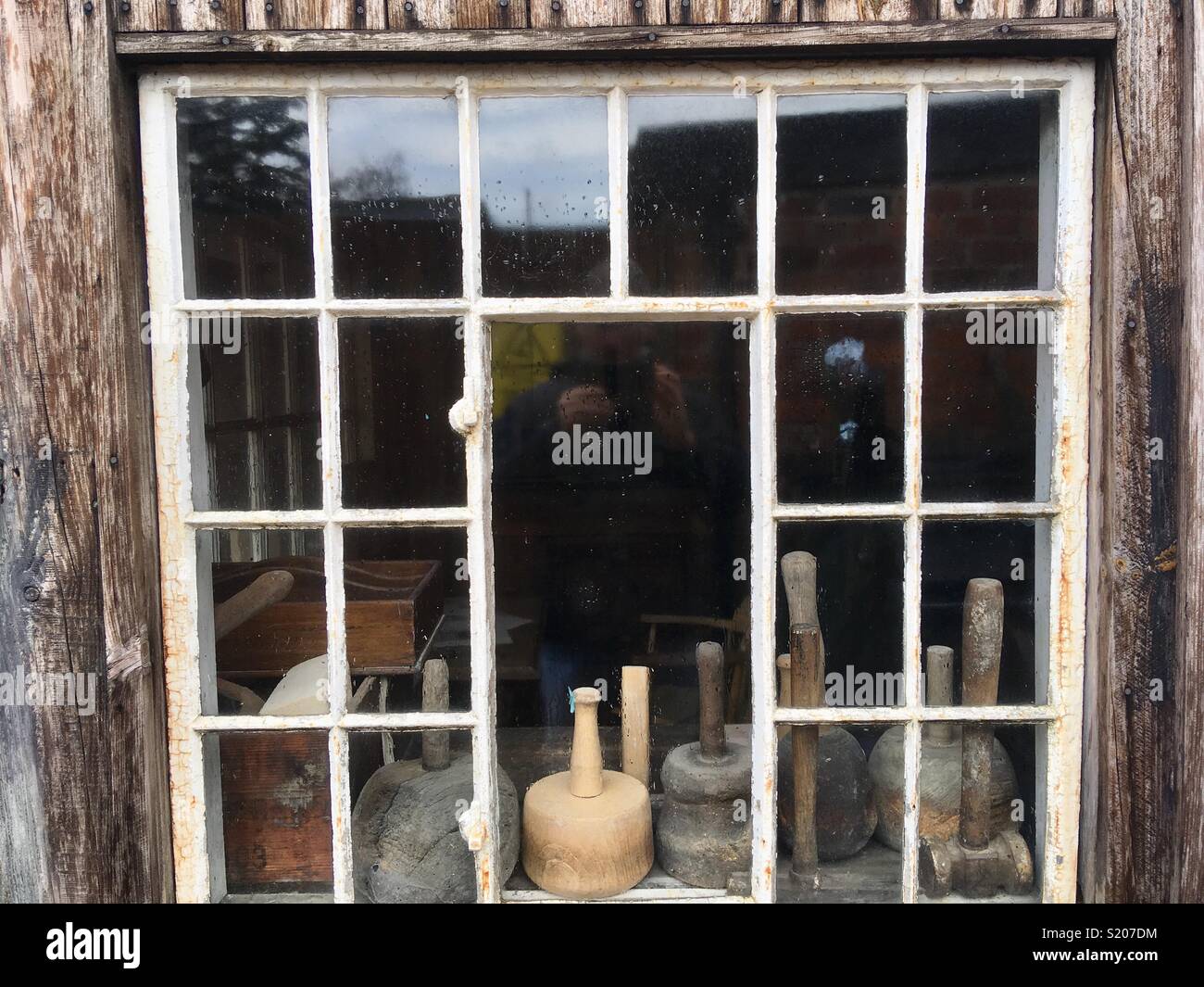 Old white painted steel window, Crittal style, in an industrial workshop - Smartphone Captured Stock Image