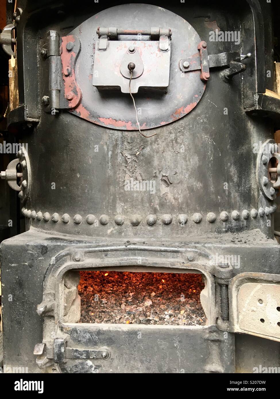 Old boiler with furnace door open Stock Photo Alamy
