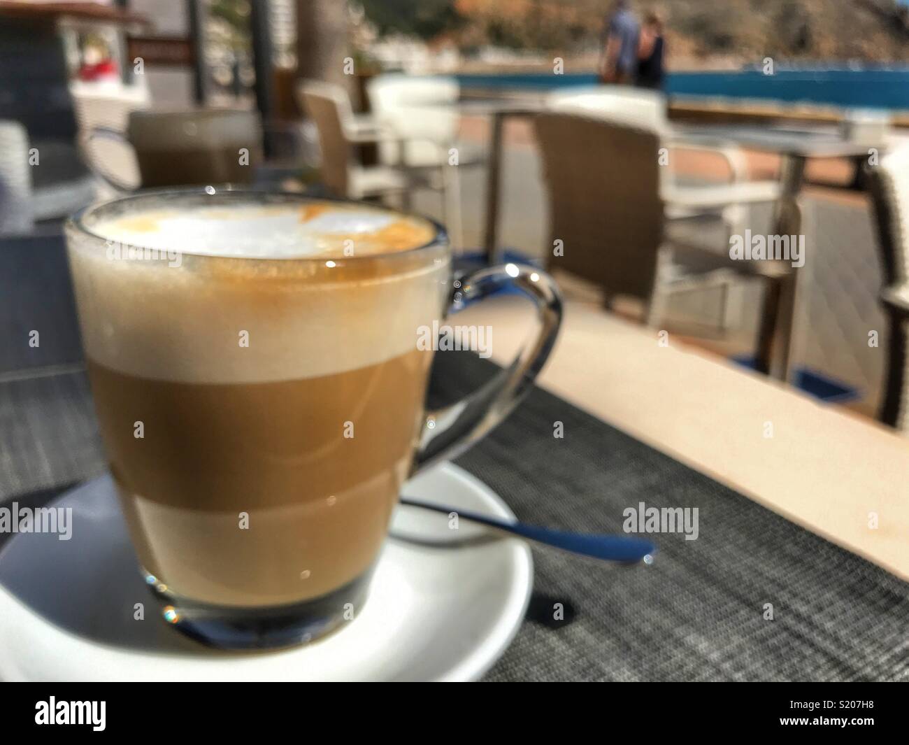 https://c8.alamy.com/comp/S207H8/cafe-con-leche-milky-white-coffee-on-a-table-in-a-cafe-on-the-waterfront-promenade-in-the-port-area-of-javea-xabia-on-the-costa-blanca-alicante-province-comunidad-valenciana-spain-S207H8.jpg