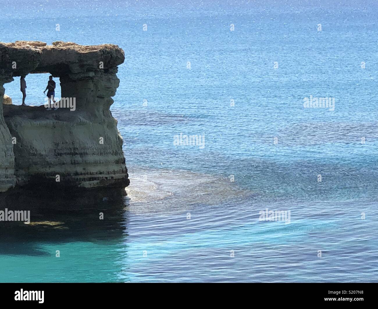 Rock on Cavo Greko on Cyprus with a male and a female silhouette - Smartphone Captured Stock Image