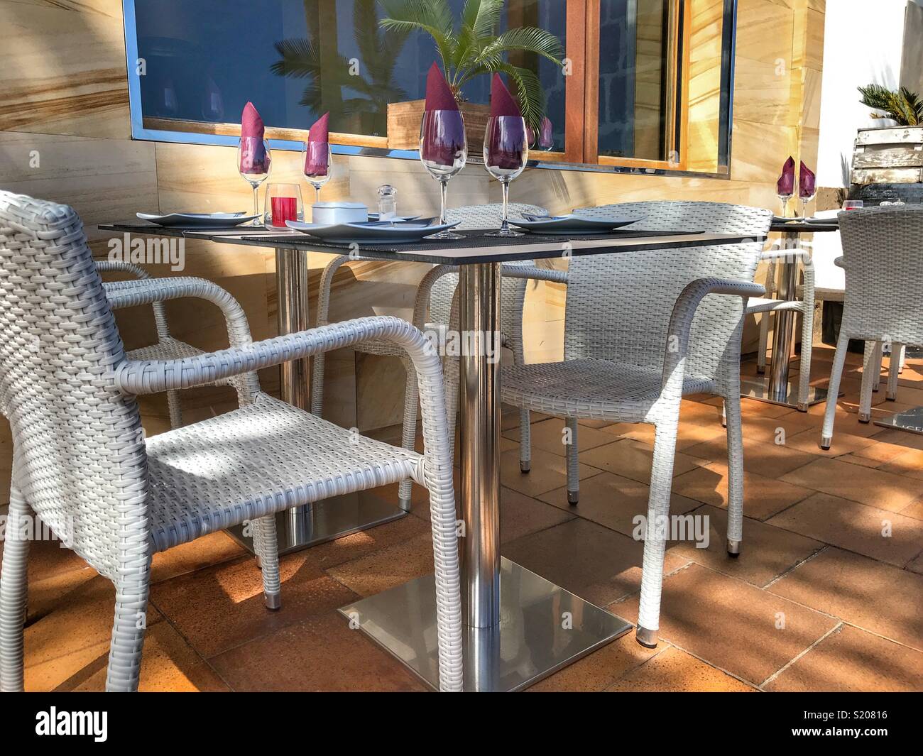 Table laid ready for guests at a restaurant on the waterfront promenade in the port area of Javea / Xabia on the Costa Blanca, Alicante Province, Comunidad Valenciana, Spain - Smartphone Captured Stock Image