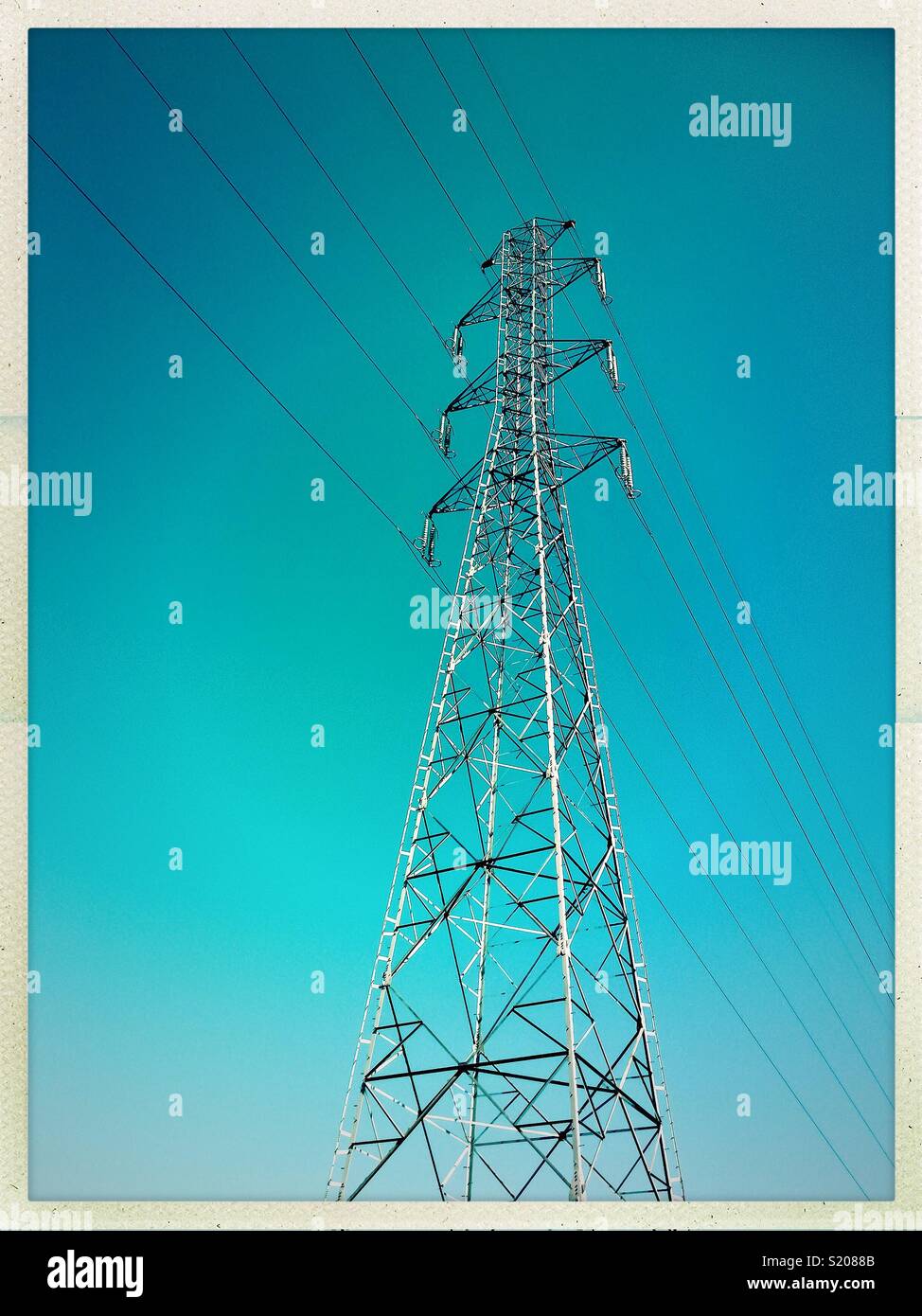High voltage metallic electric tower isolated on a blue sky, France. - Smartphone Captured Stock Image