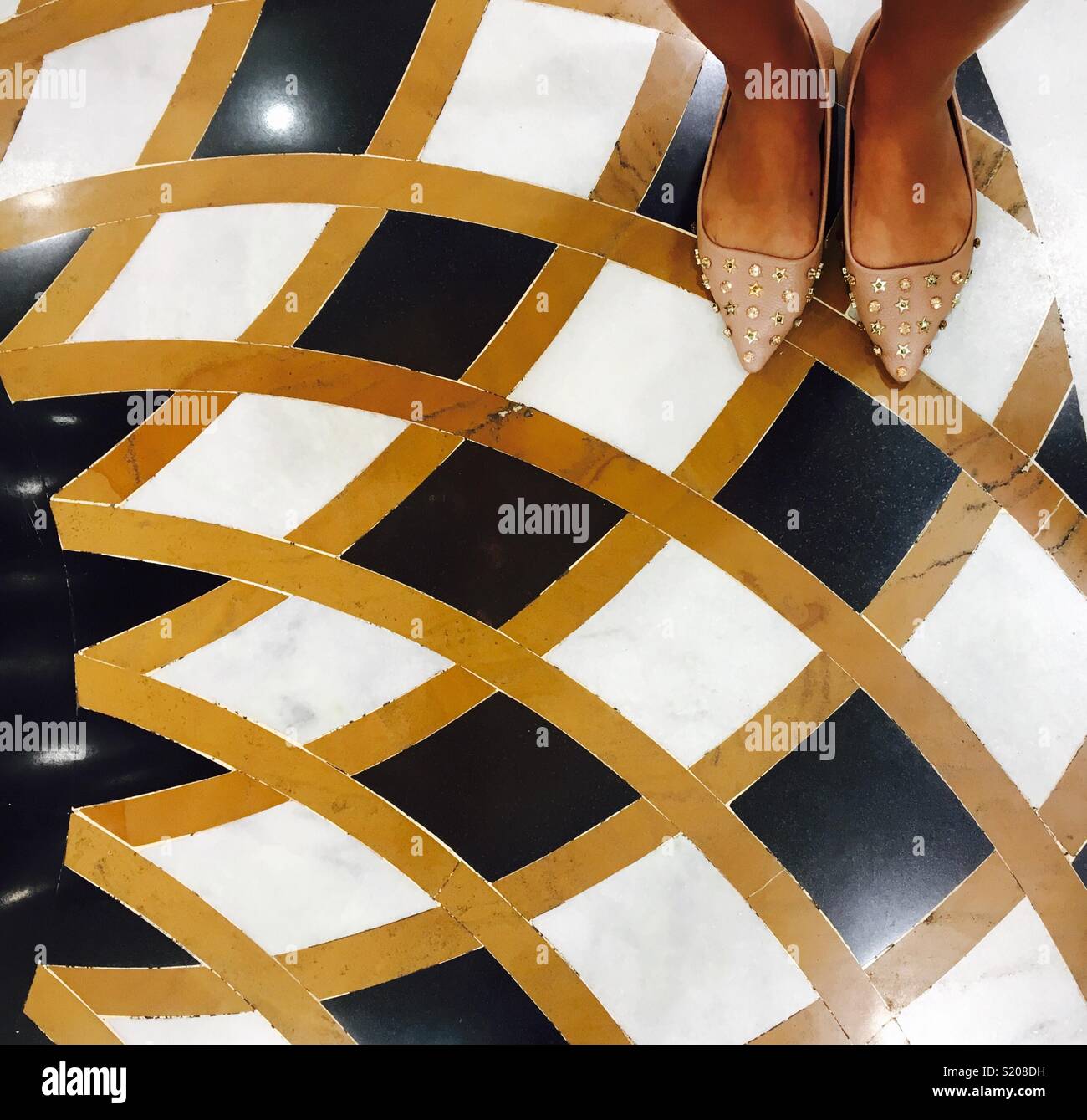 Beautiful feet on tiles Stock Photo