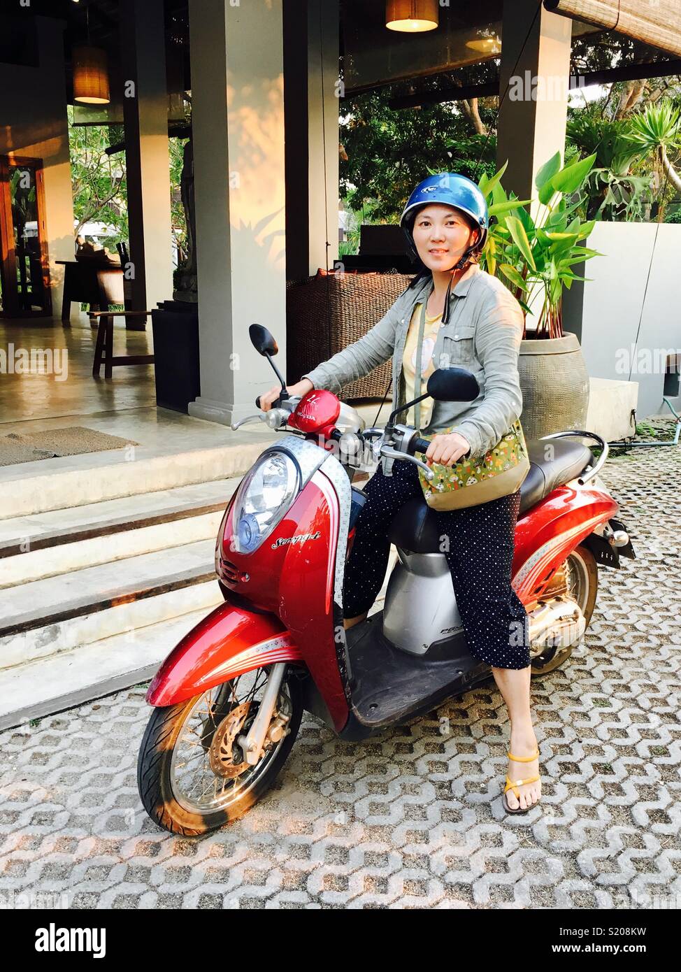 Asian female tourist with motorbike, Pai , Northern Thailand - Smartphone Captured Stock Image