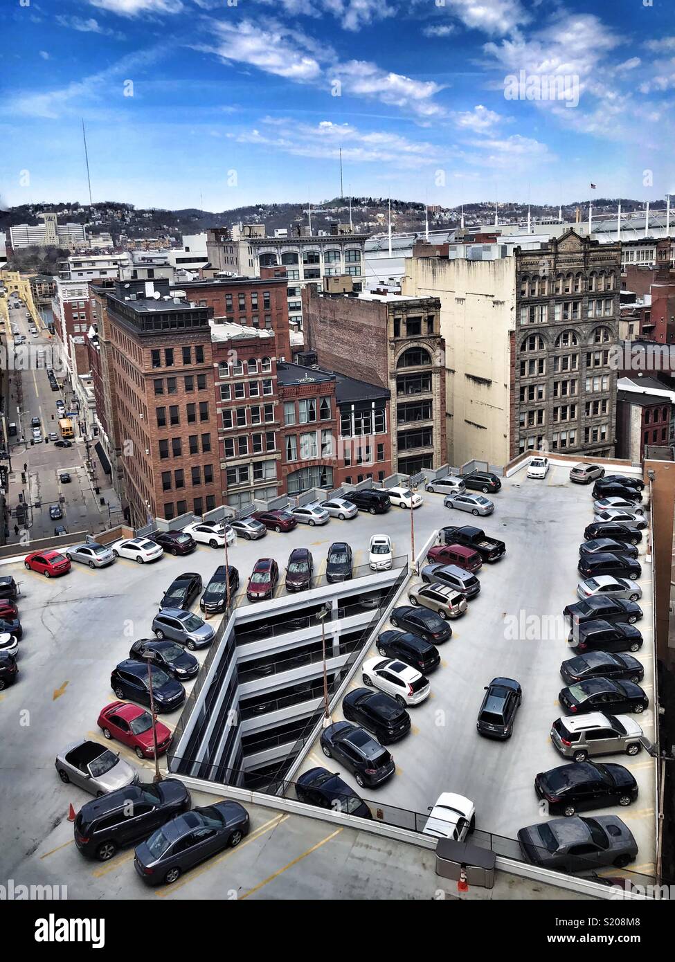 An aerial view of a parking lot amidst buildings in Pittsburgh, PA - Smartphone Captured Stock Image