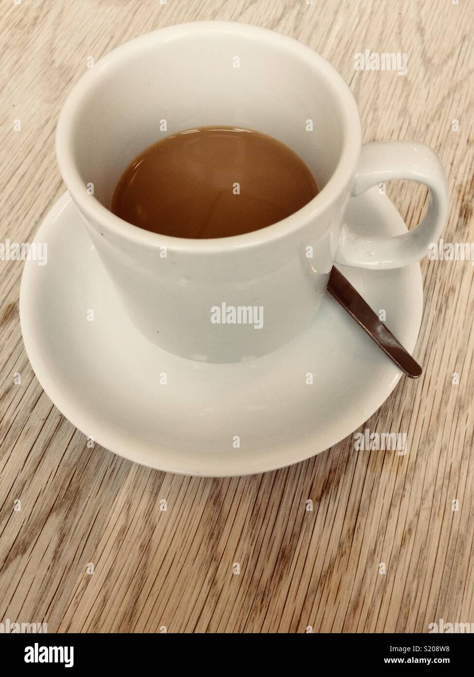 Half a cup of coffee on a wooden table Stock Photo