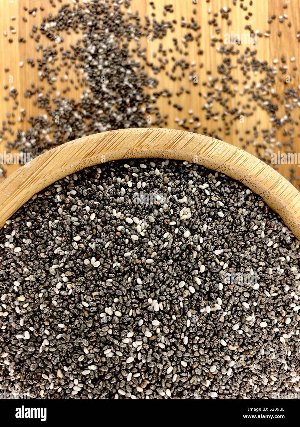 Chia seeds in a wood bowl Stock Photo