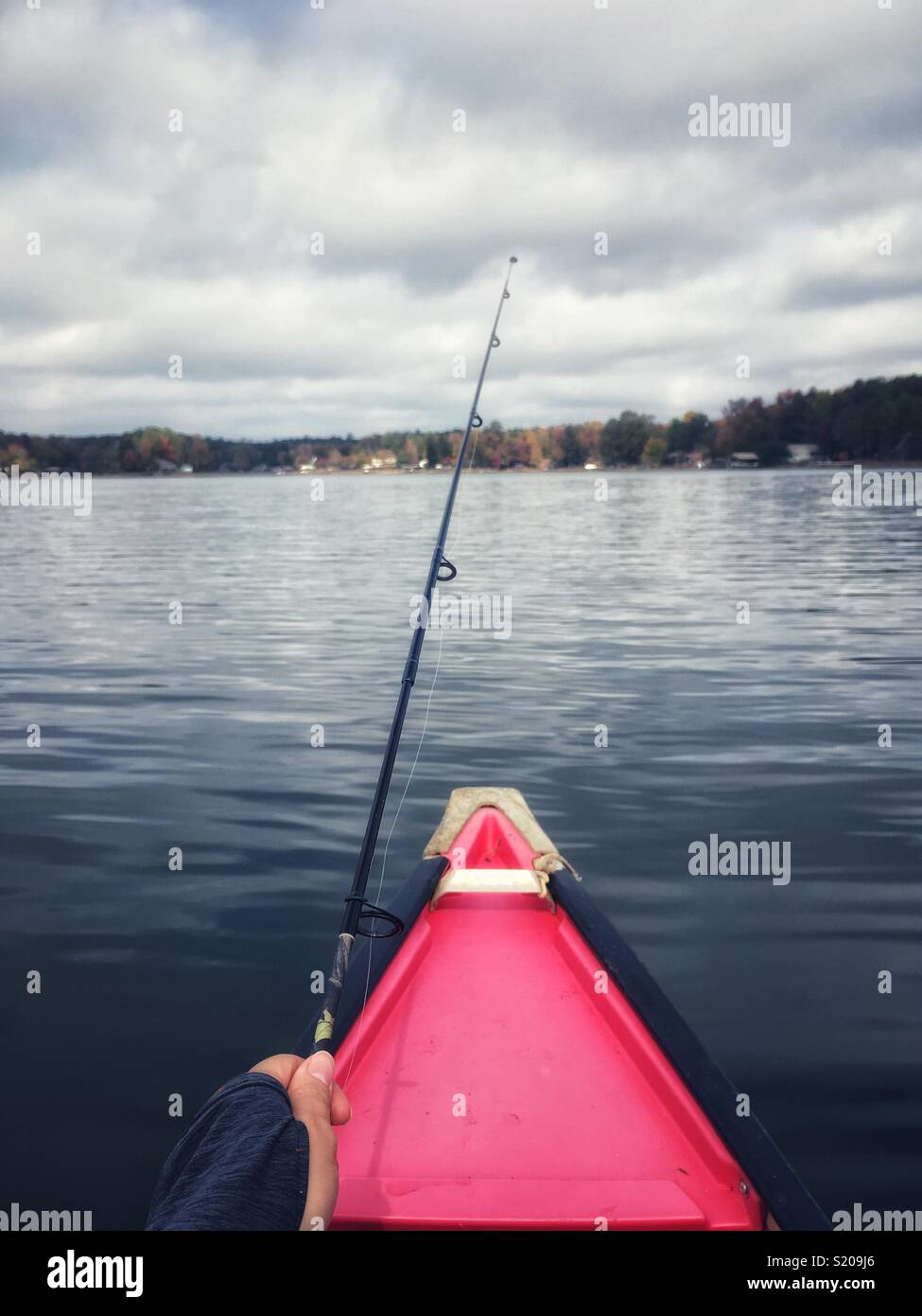 Fishing from a canoe on a lake - Smartphone Captured Stock Image