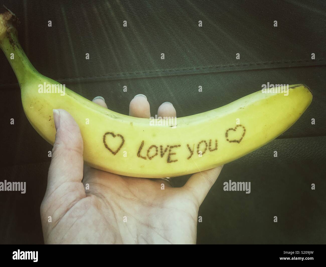 I love you sign carved on a banana - Smartphone Captured Stock Image