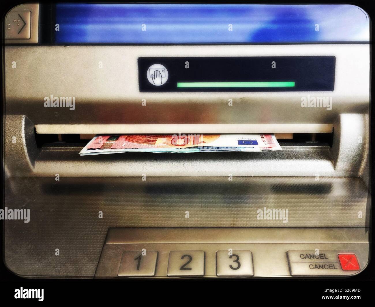 ATM machine with euro banknotes Stock Photo