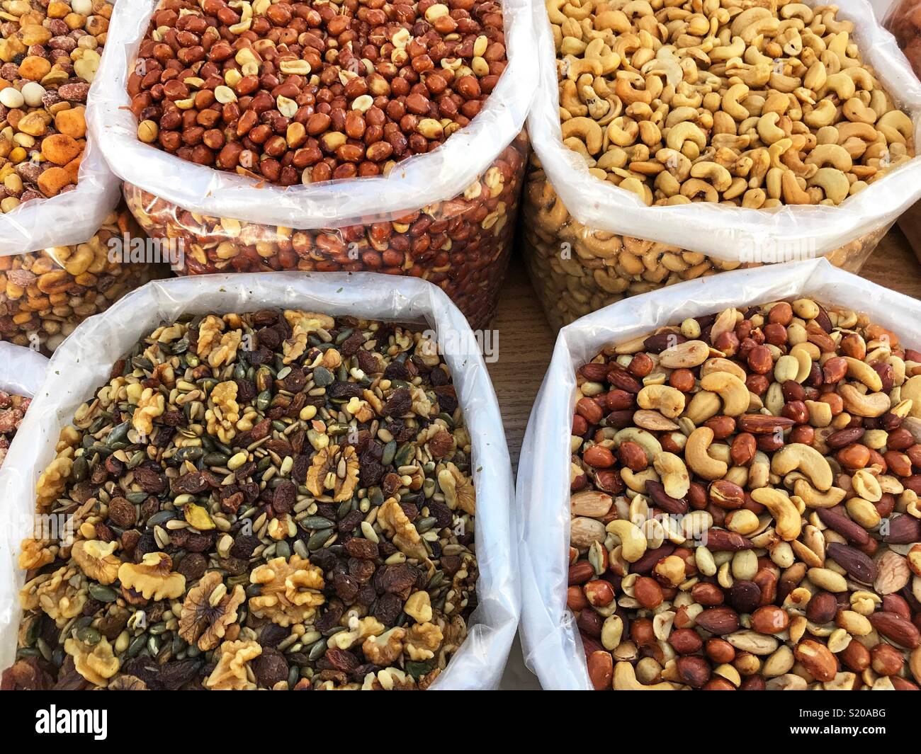 Nuts, including mixed nuts, peanuts, cashew nuts, walnuts and raisins, for sale on a market stall in Javea, Spain Stock Photo