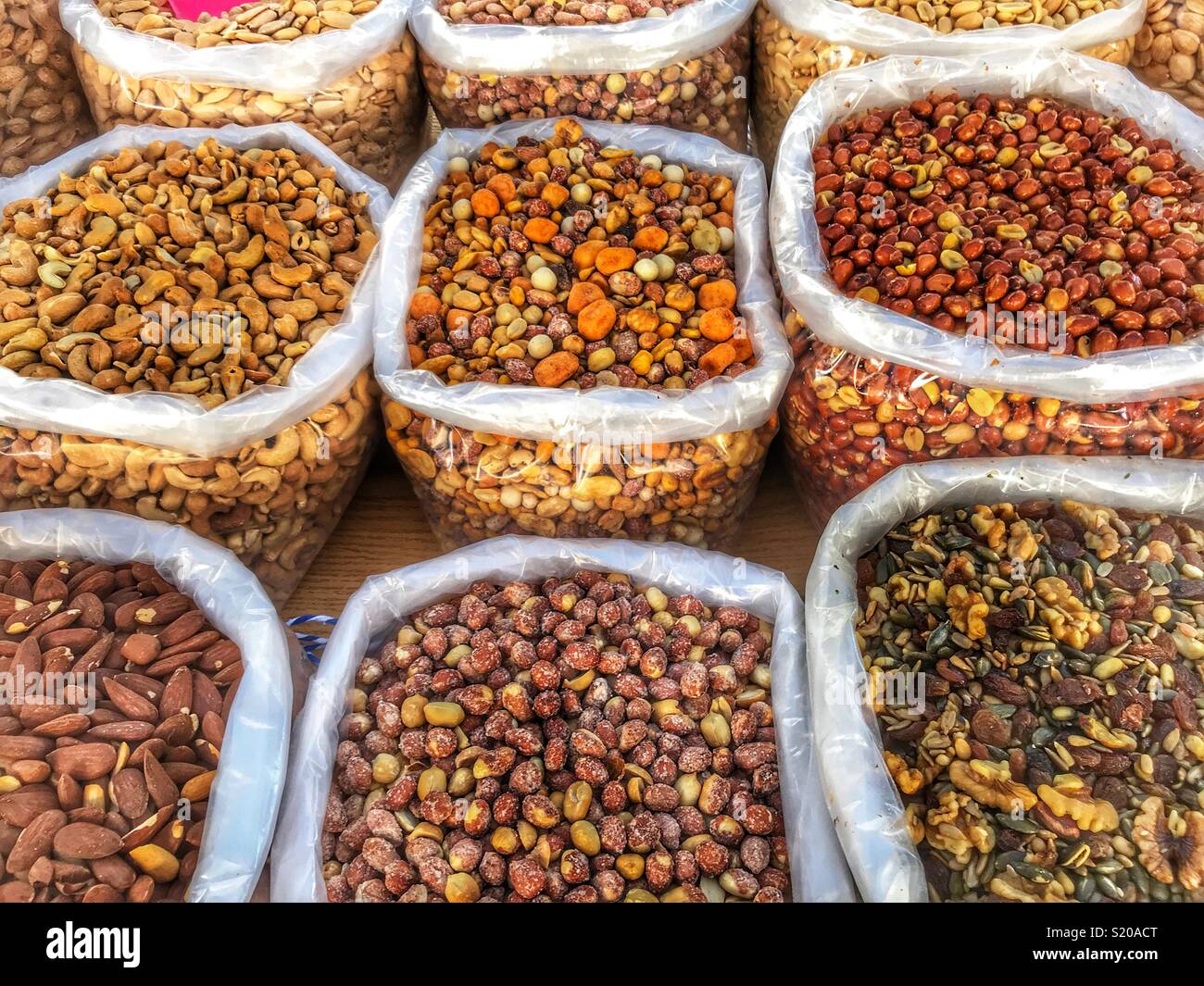 Variety of nuts including peanuts, almonds, Walnuts and raisins, cashew nuts, mixed nuts, for sale on a market stall in Javea, Spain Stock Photo
