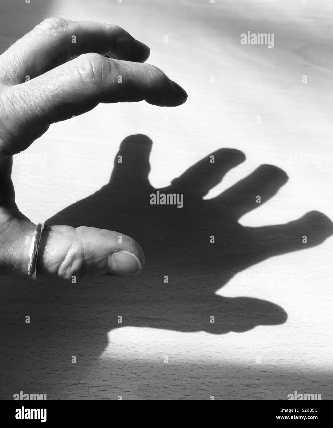 Dramatic shadow created by hand Stock Photo Alamy