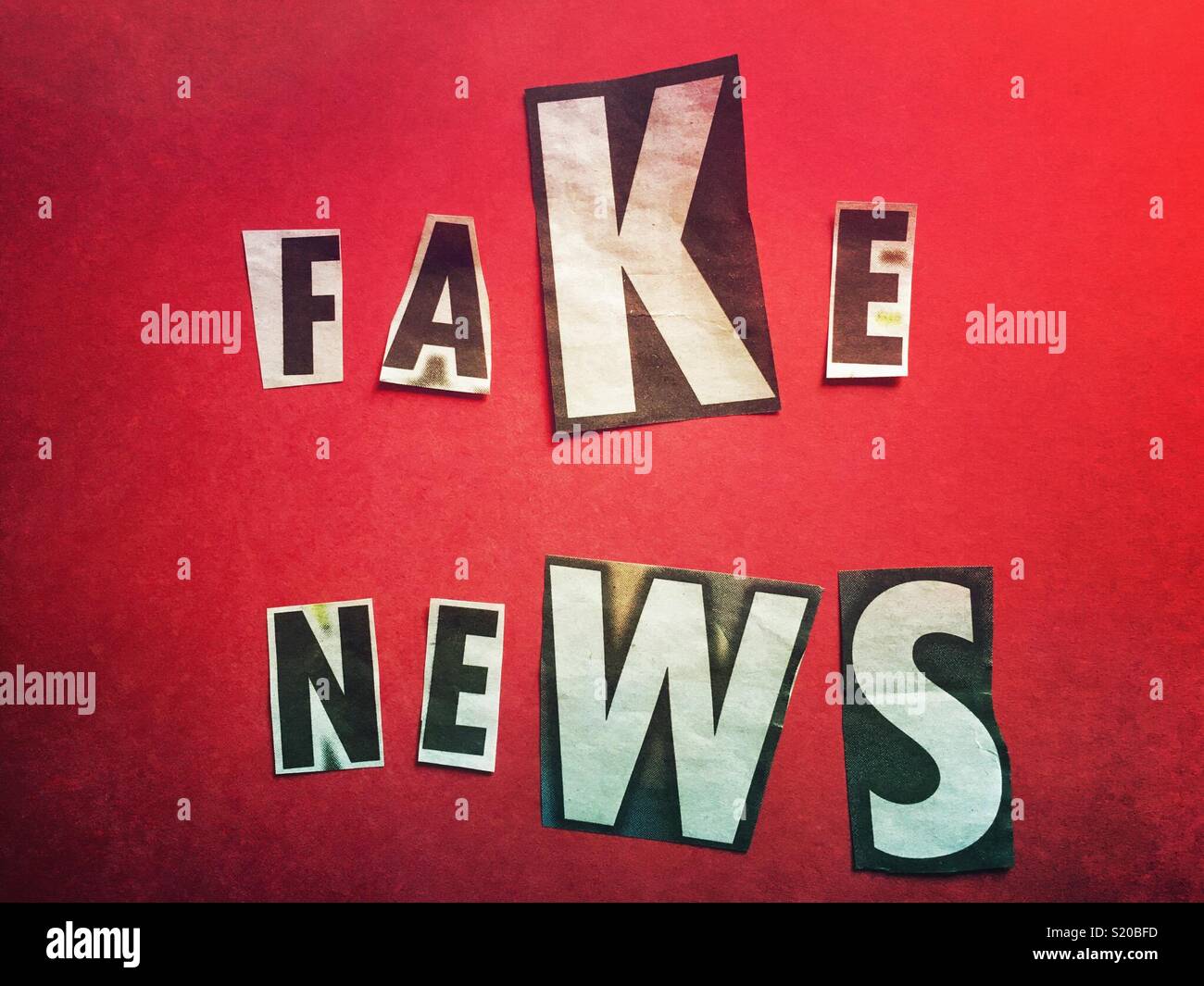 Fake news spelled out on a red background - Smartphone Captured Stock Image