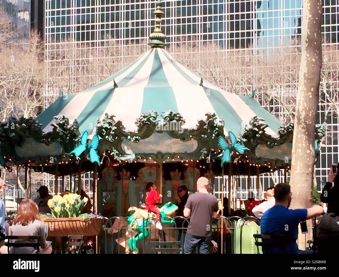 Festive children’s merry-go-round carousel, Bryant Park, New York City, USA - Smartphone Captured Stock Image