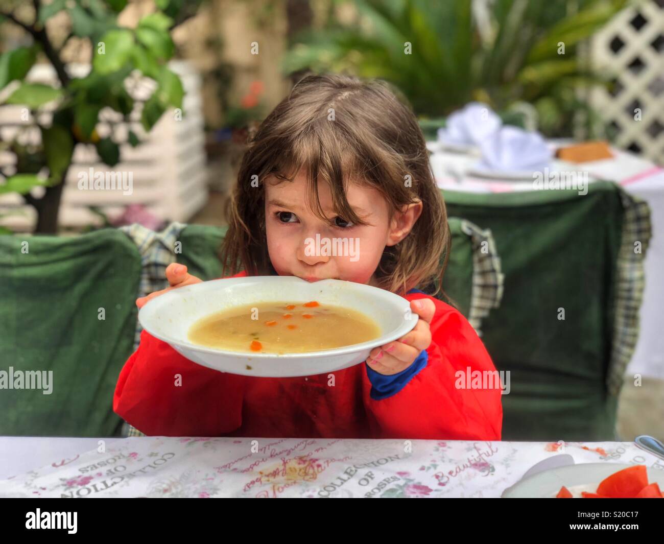 Cute little girl eating a soup Stock Photo