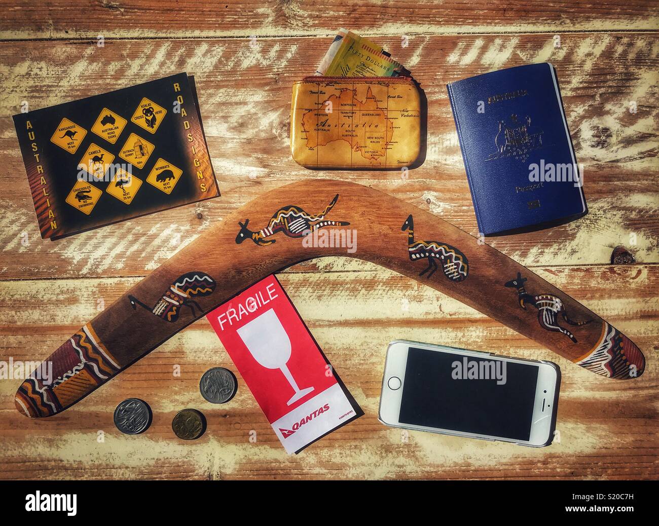 Flatlay photography, Australia holiday travel theme, boomerang, Australian passports, postcard, purse, AUD $, money - Smartphone Captured Stock Image