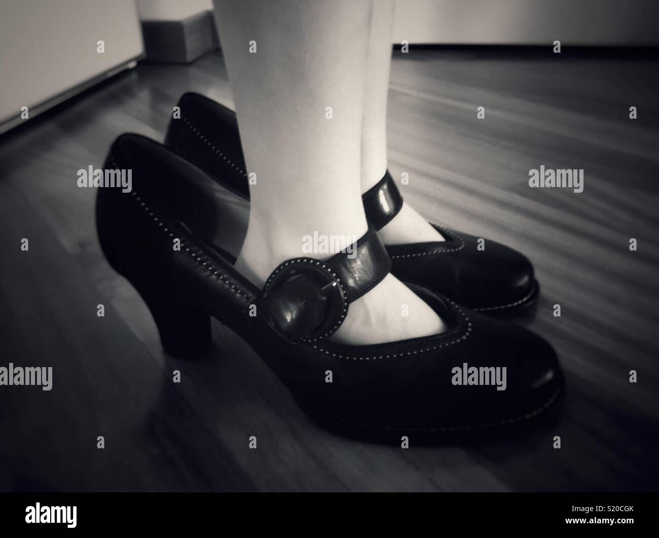 Child trying on mom’s shoes. - Smartphone Captured Stock Image