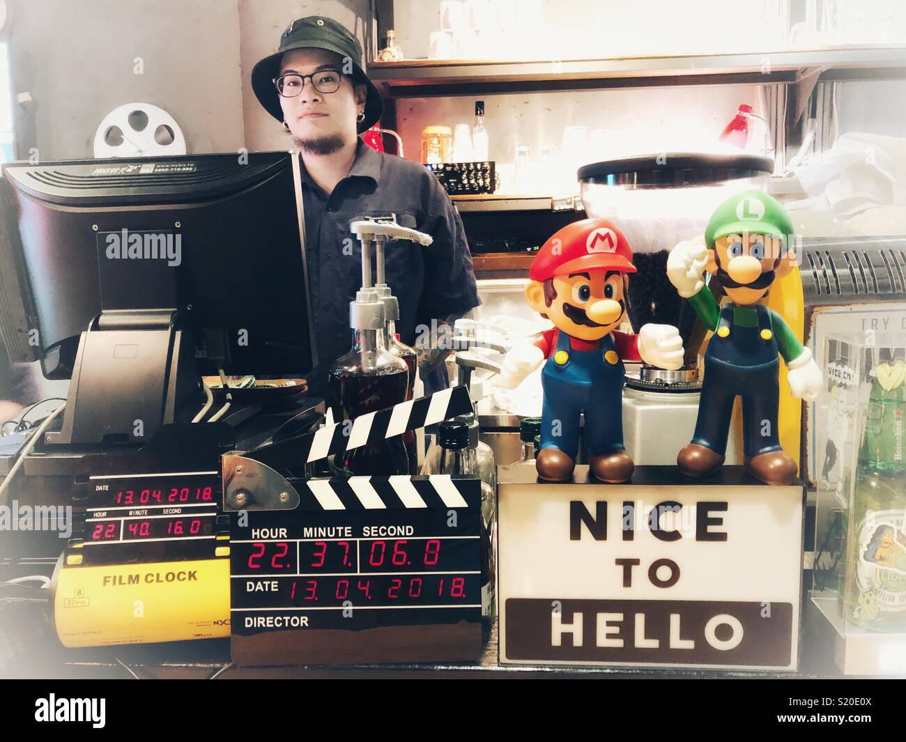 Restaurant server standing behind counter in Taipei, Taiwan. Stock Photo