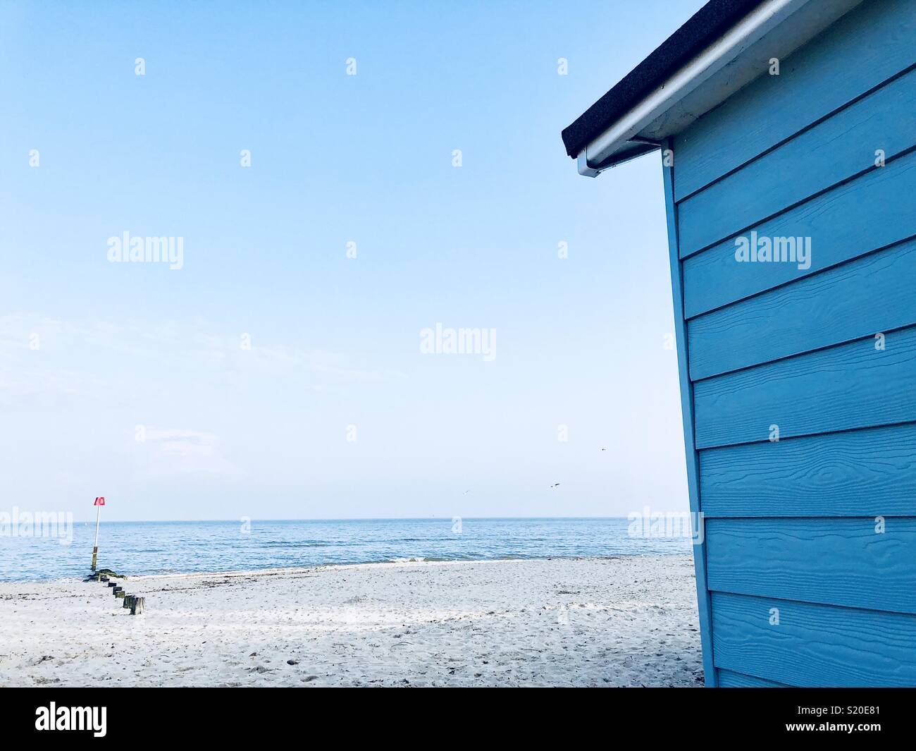 Blue Beach hut on a sandy beach in Mudeford - Smartphone Captured Stock Image