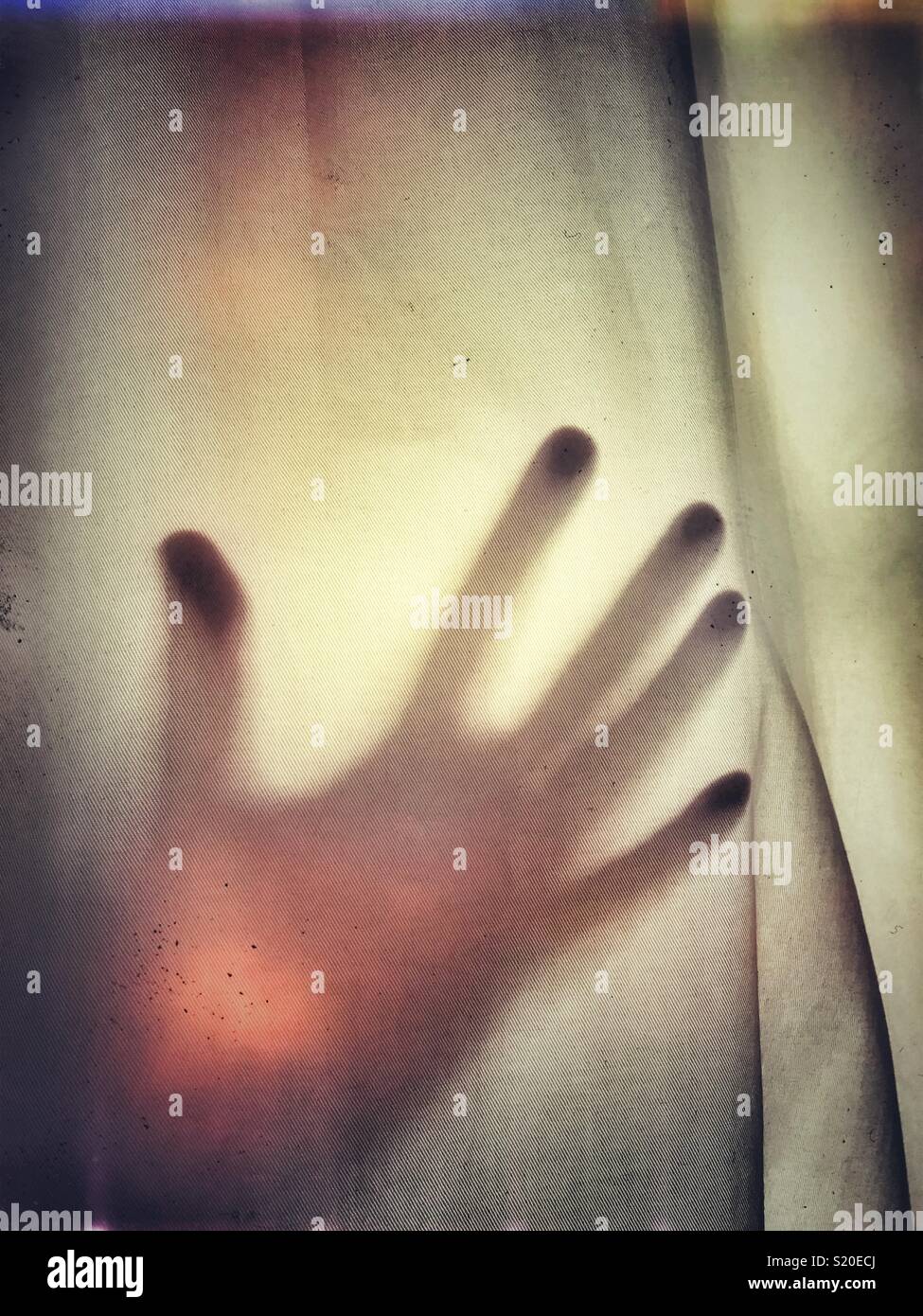 An outstretched hand against fabric - Smartphone Captured Stock Image