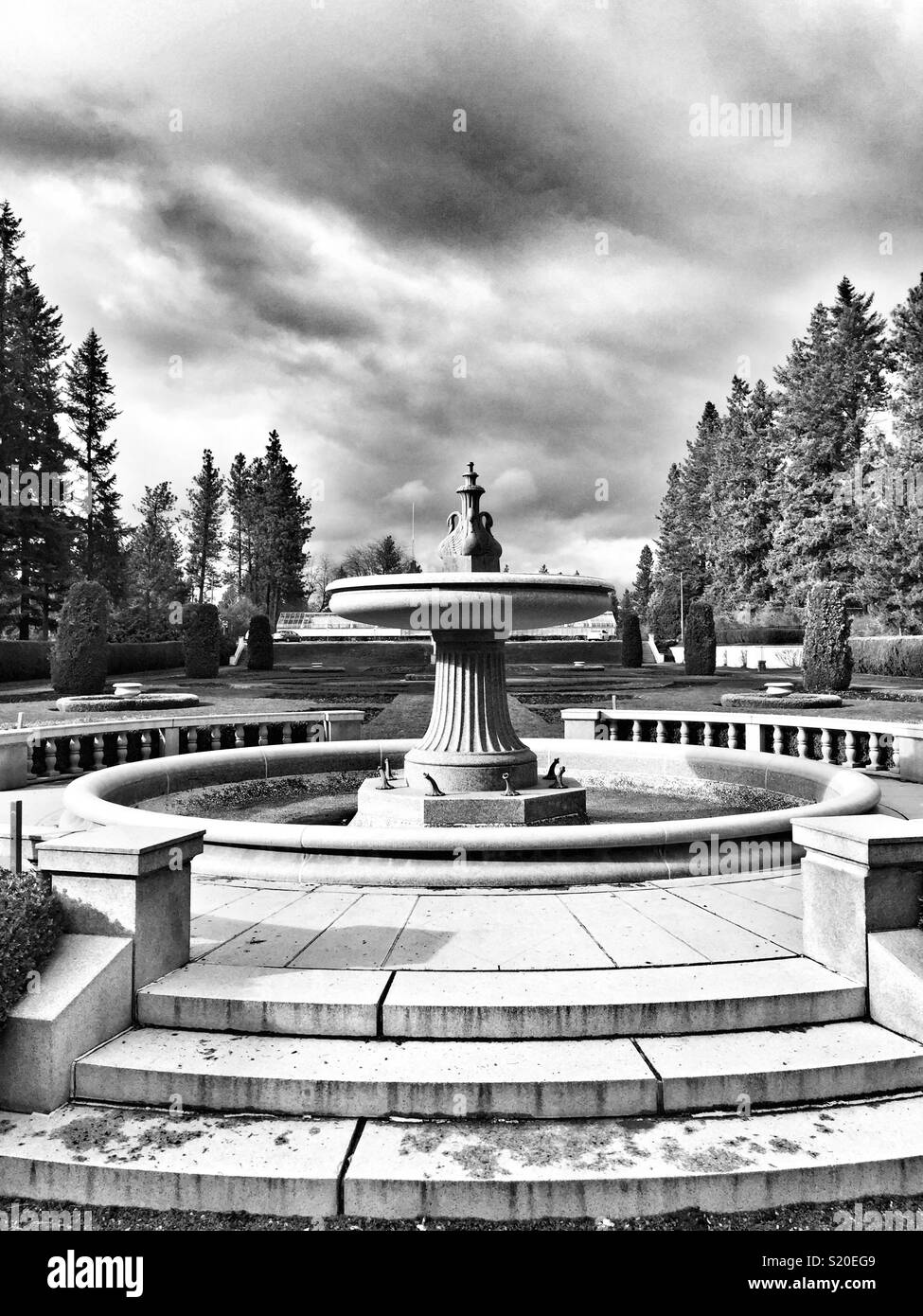 Famous granite fountain circa 1913 waiting for warmer weather at the formal Duncan garden of Manito Park in Spokane WA - Smartphone Captured Stock Image