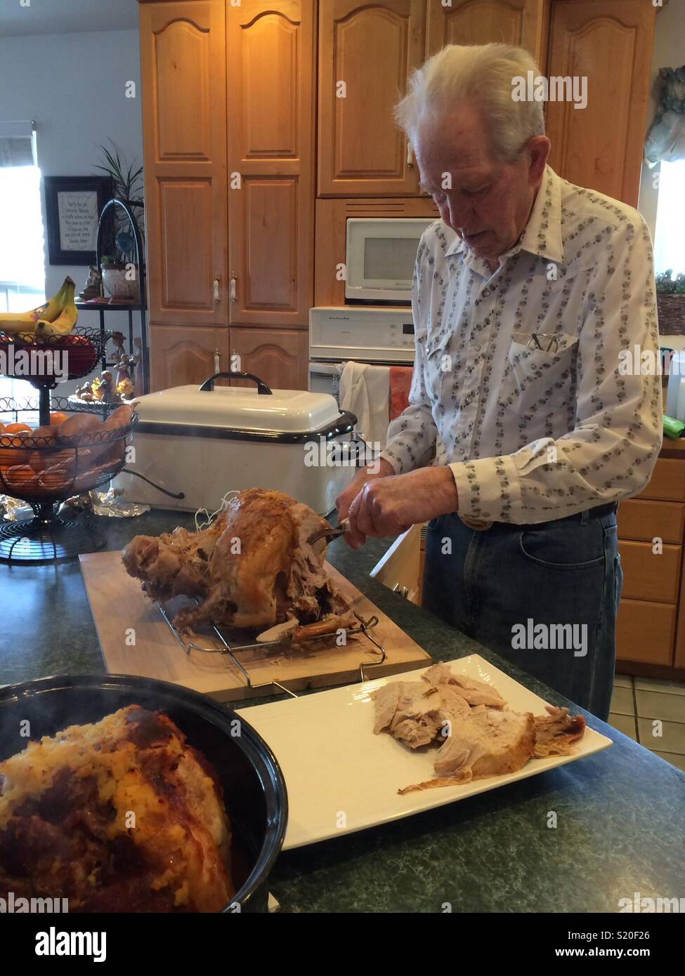 Grandpa carving the turkey Stock Photo