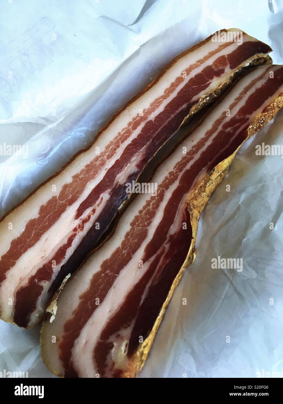 Italian pancetta bacon on wrapping paper Stock Photo - Alamy