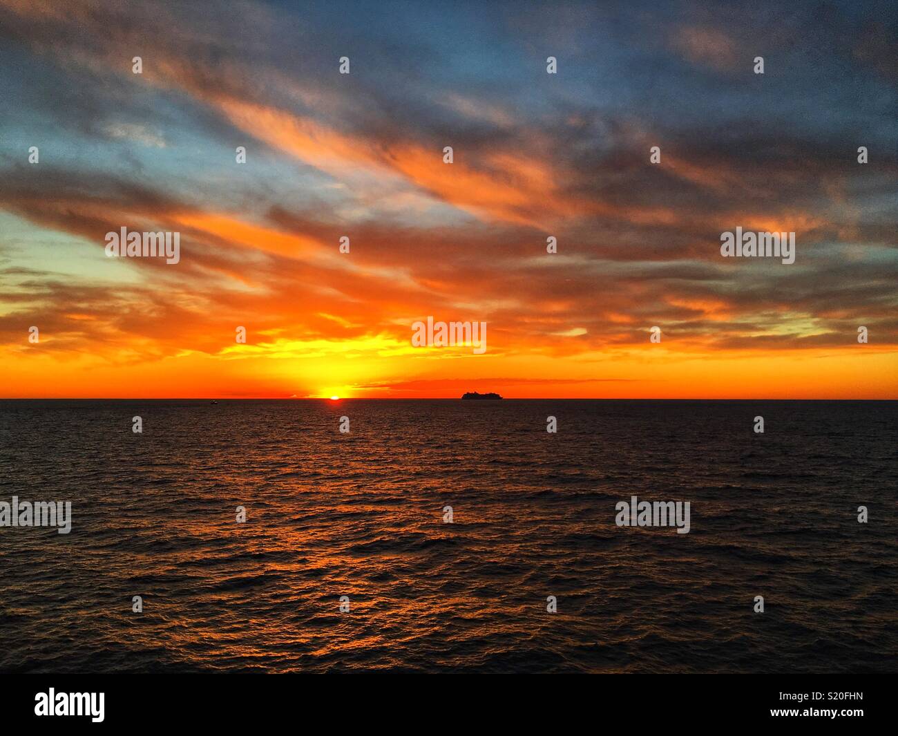 Cruise ship on horizon at sunset - Smartphone Captured Stock Image