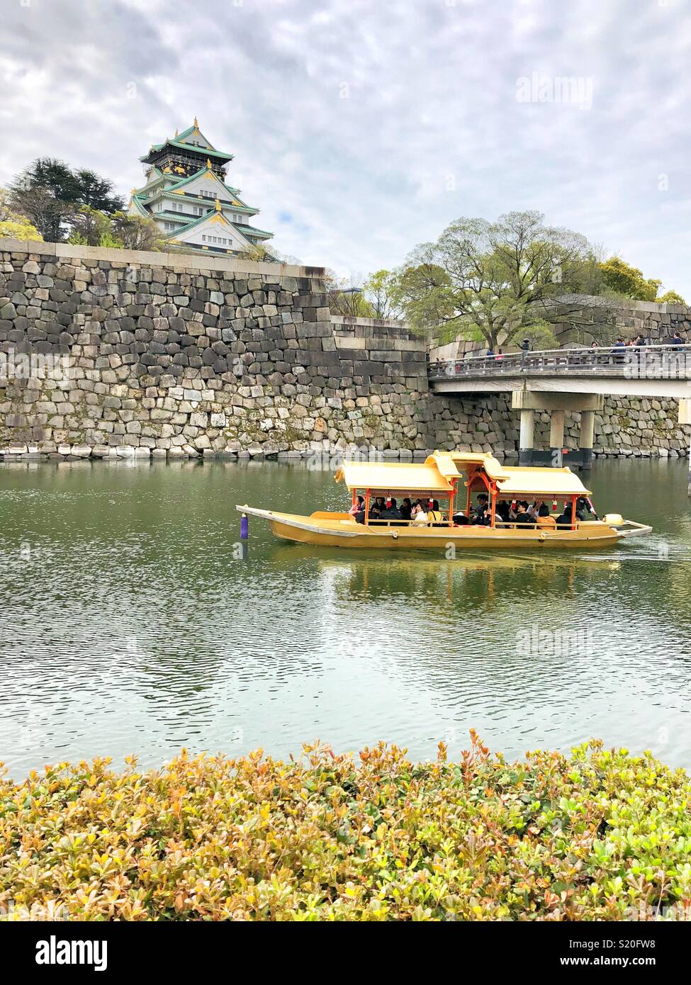 Tourists taking a boat ride on the moat around Osaka Castle in Japan. - Smartphone Captured Stock Image