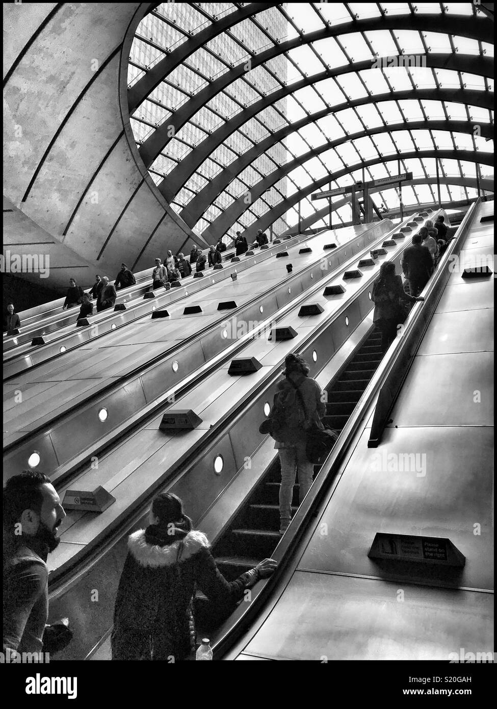 The famous escalators at Canary Wharf Underground (Tube) Station in the Docklands Area Of London. This station is on the Jubilee Line & is part of the DLR system. Photo Credit - © COLIN HOSKINS. - Smartphone Captured Stock Image