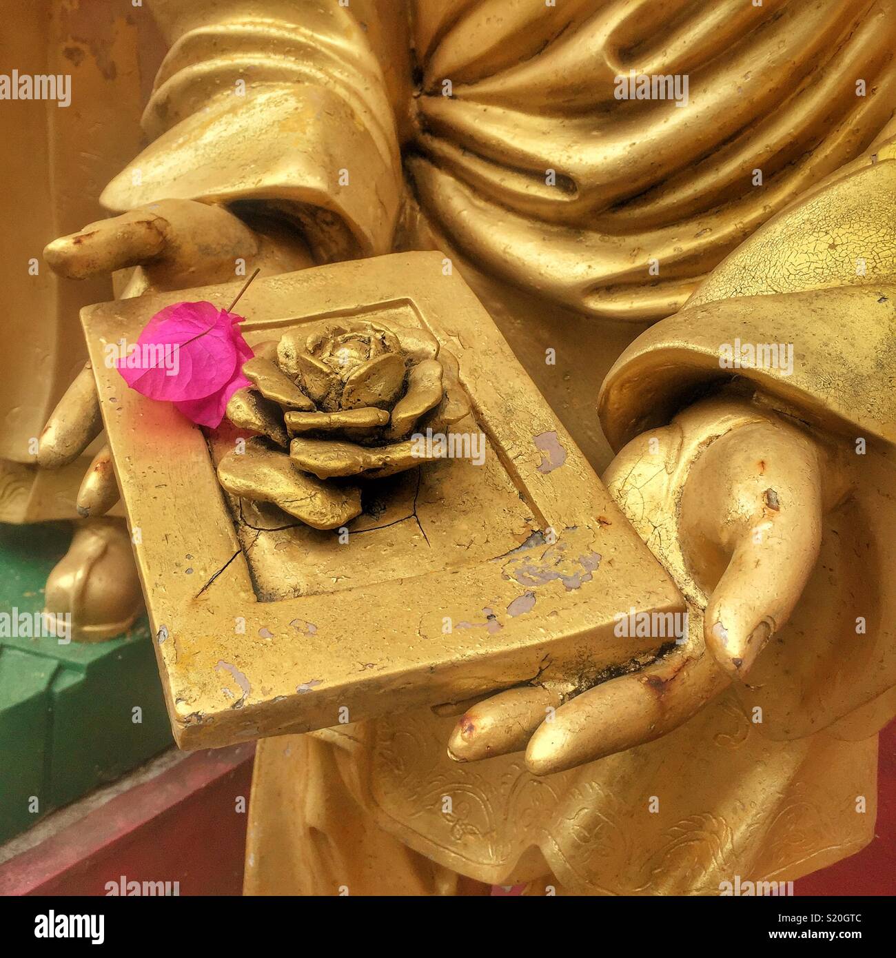 Detail of one of the Golden statues of Buddhist 'arhats' lining the path leading to the Ten Thousand Buddhas Monastery in Sha Tin, New Territories, Hong Kong - Smartphone Captured Stock Image