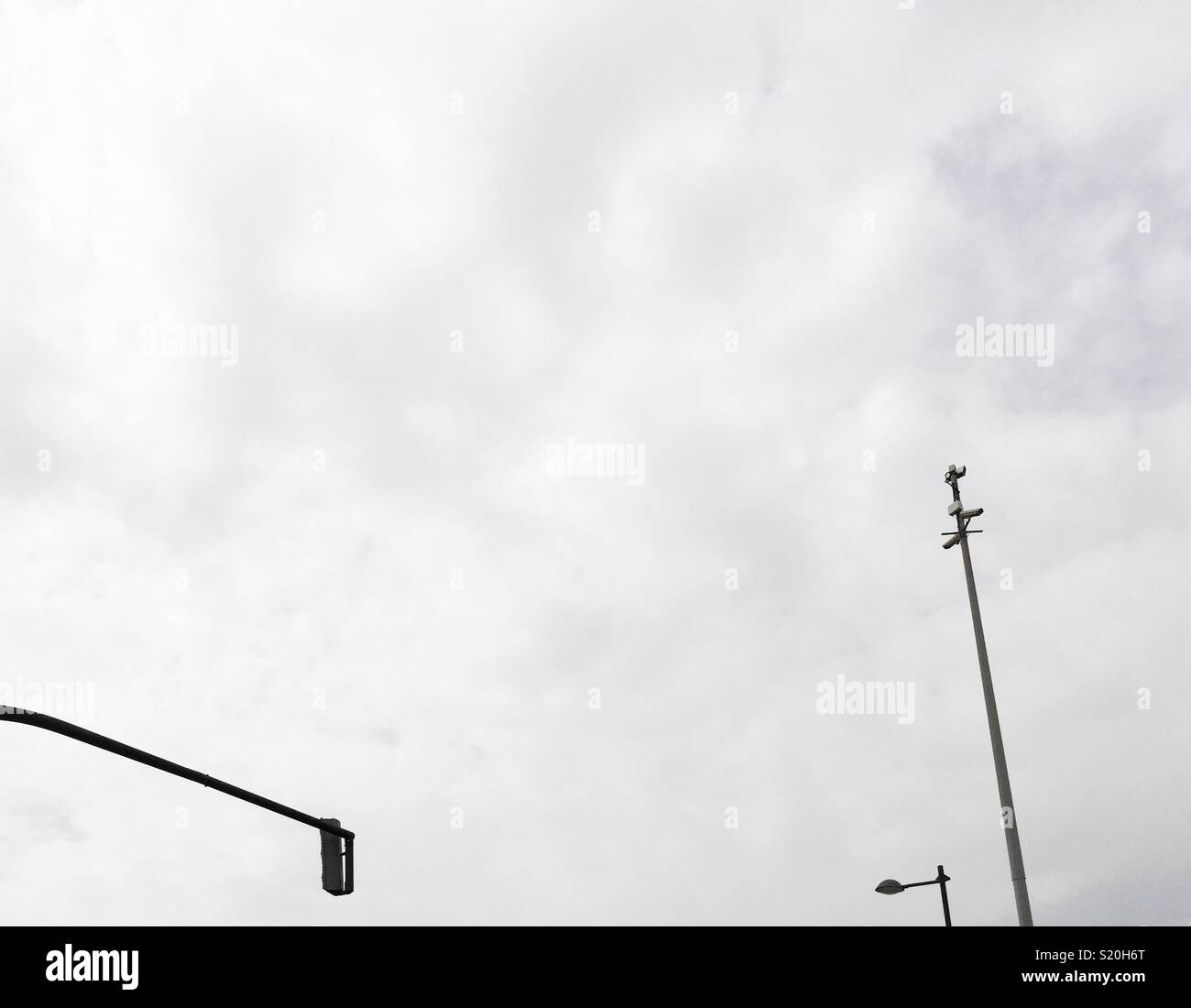 Traffic lights, street lamp and security camera tower in the city - Smartphone Captured Stock Image